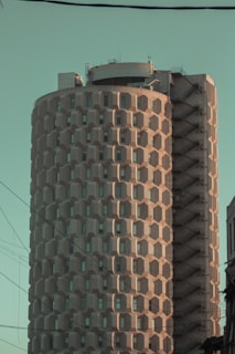 brown and black concrete building under blue sky during daytime
