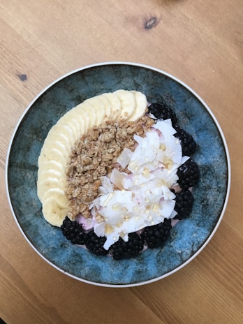An inviting breakfast bowl with granola, berries, and a drizzle of honey.
