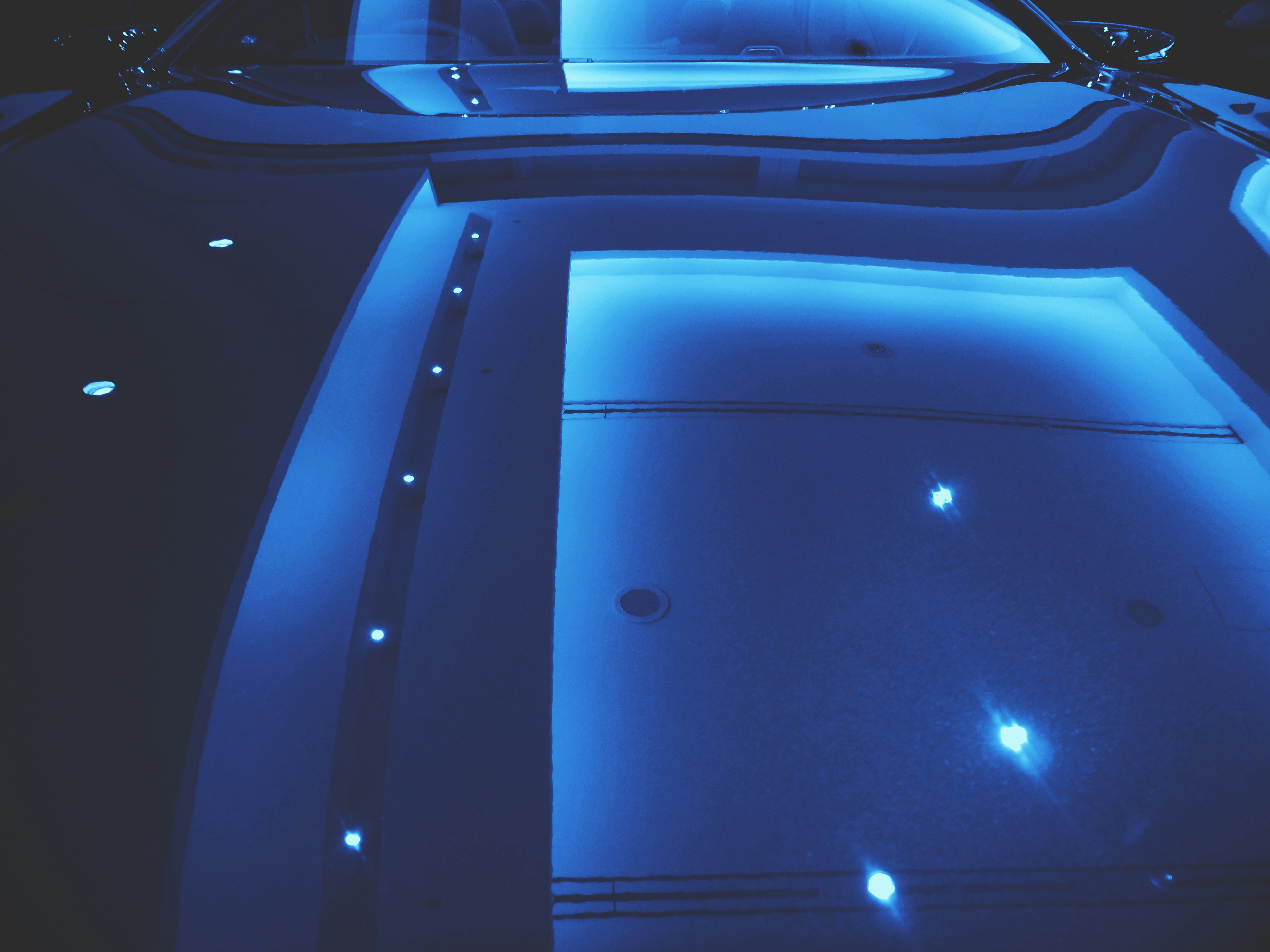 Futuristic electric vehicle interior with ambient lighting and digital displays