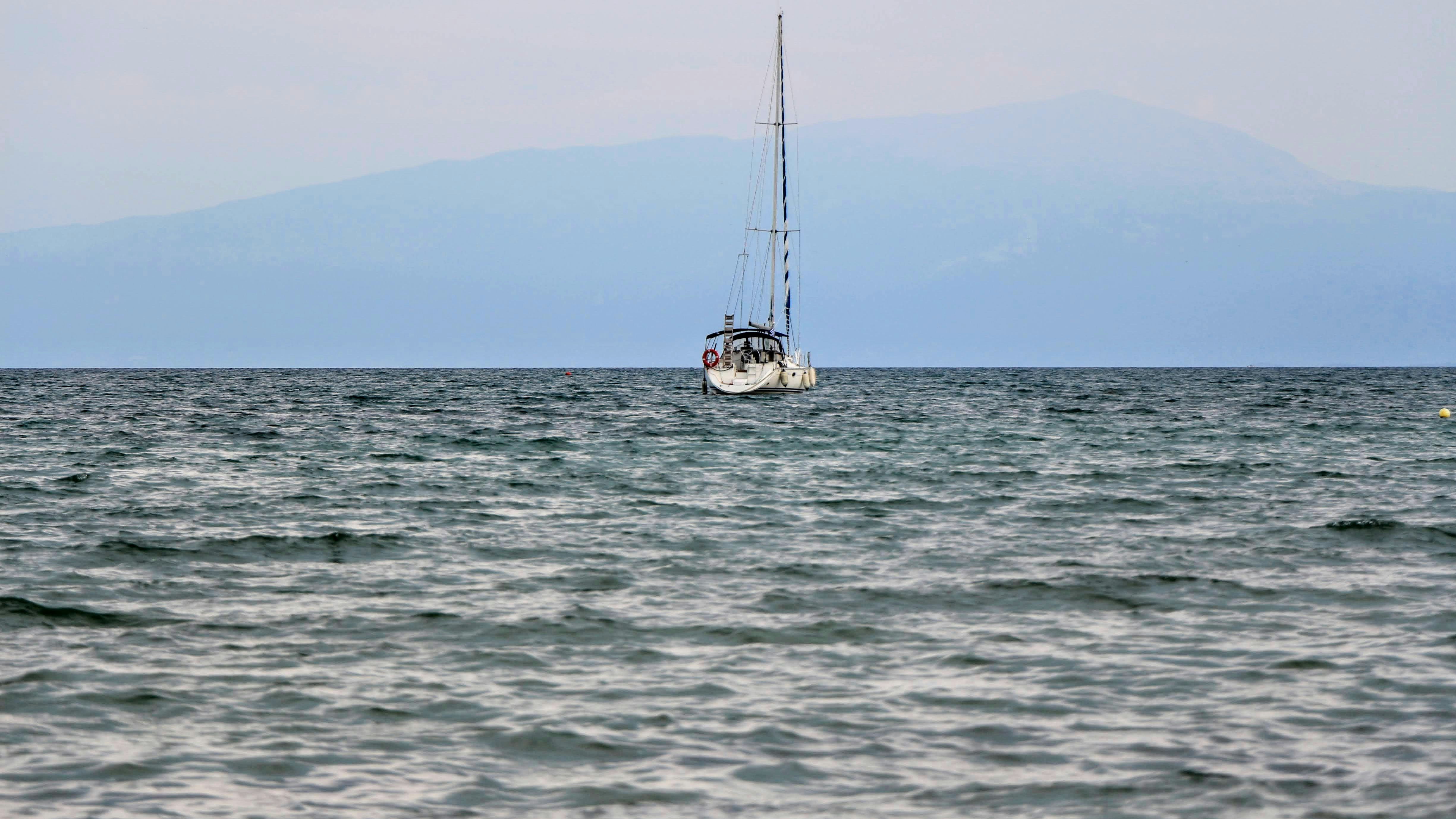 white and black boat on sea during daytime