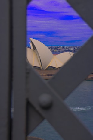 A serene beach in Sydney with the Opera House in the background.