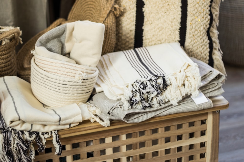 white and black floral textile on brown woven armchair