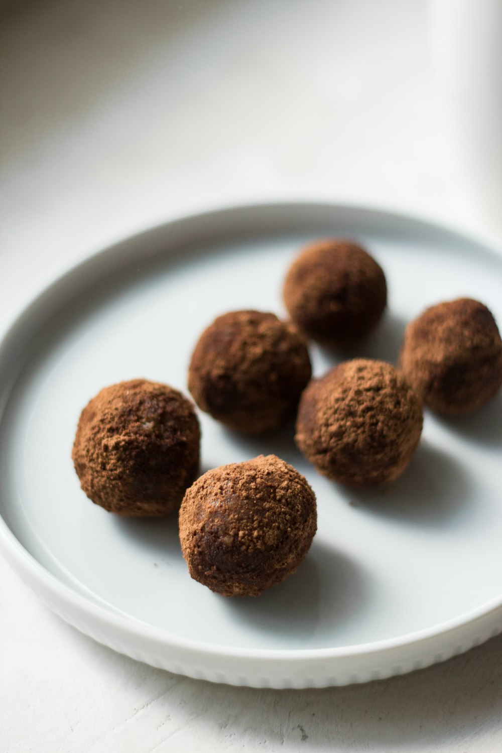 brown round food on white ceramic plate