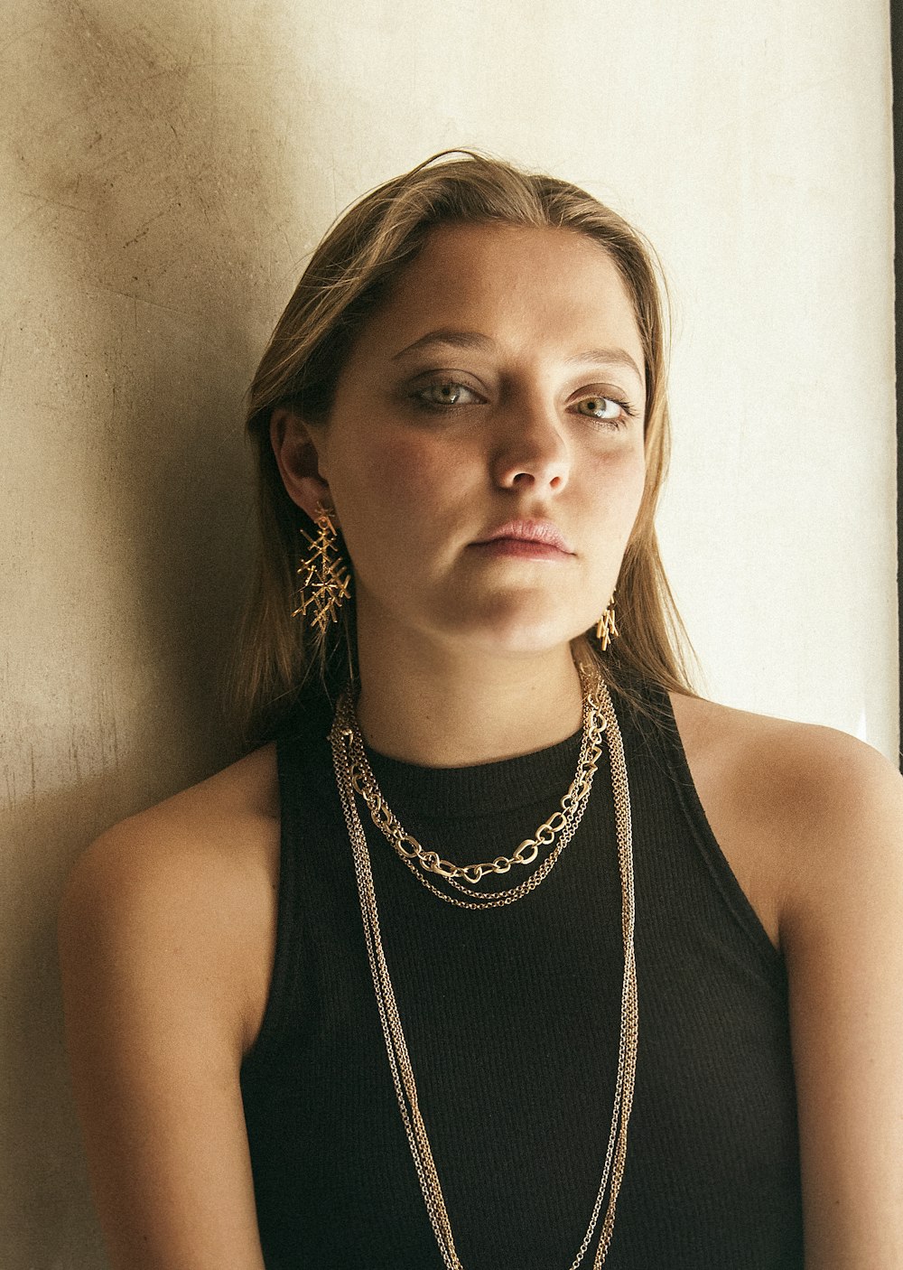 woman in black tank top wearing silver necklace