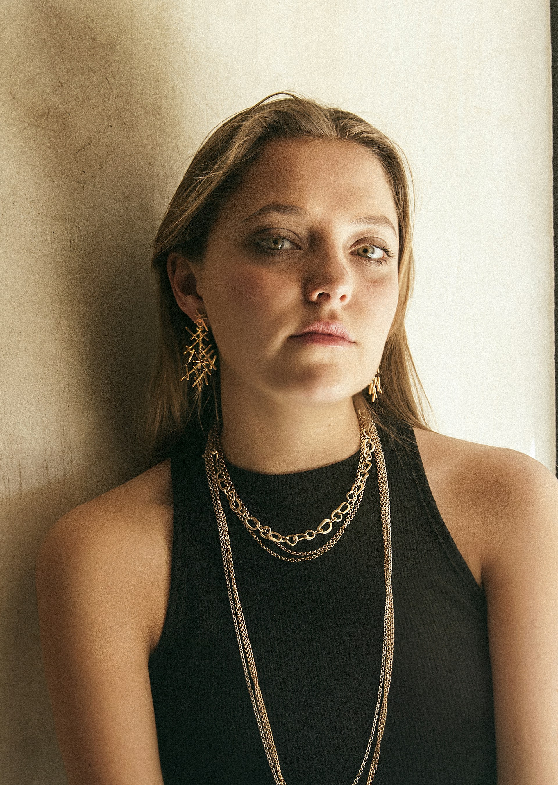 woman in black tank top wearing silver necklace