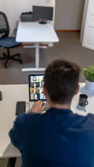 boy in blue sweater using ipad