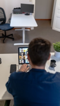 boy in blue sweater using ipad