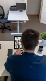 boy in blue sweater using ipad