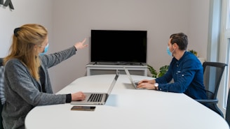 man in blue dress shirt using macbook pro