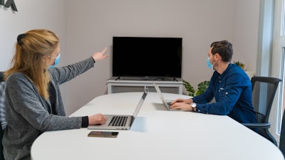 man in blue dress shirt using macbook pro