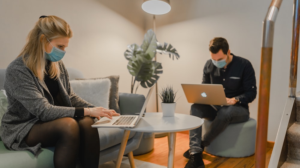 woman in black and white long sleeve shirt using macbook