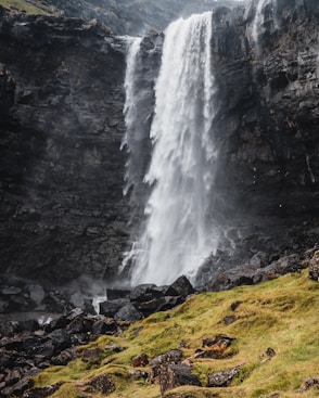 waterfalls on rocky mountain during daytime