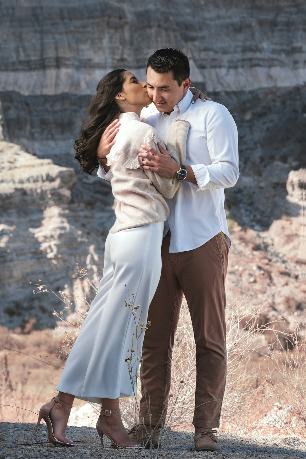 man in white dress shirt carrying woman in white dress