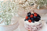 Delicate engraved plaque and cake topper arranged with fresh flowers.