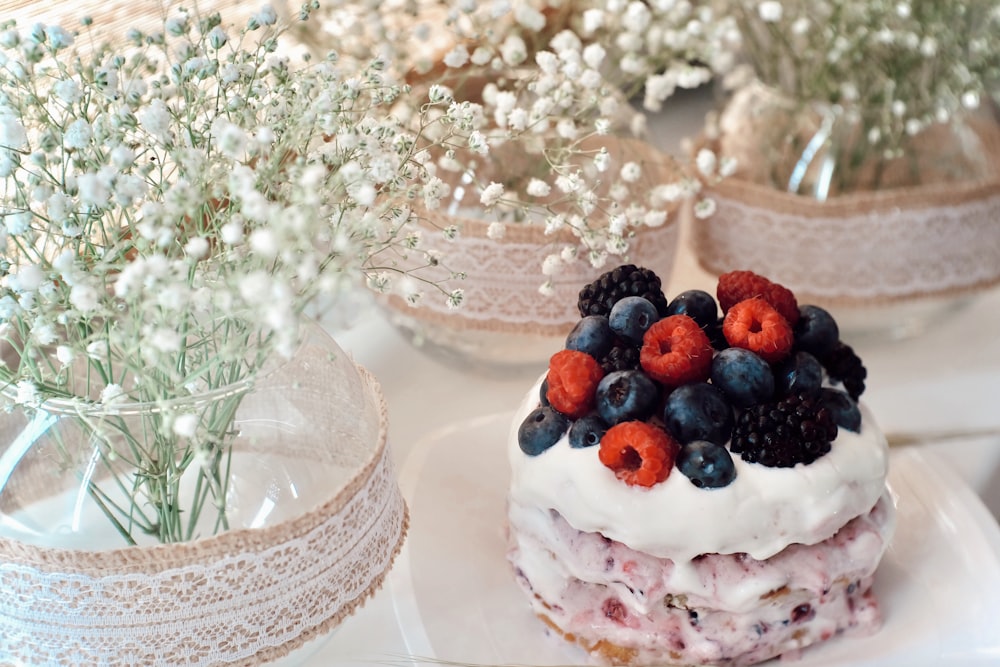 white and brown cake with berries on top