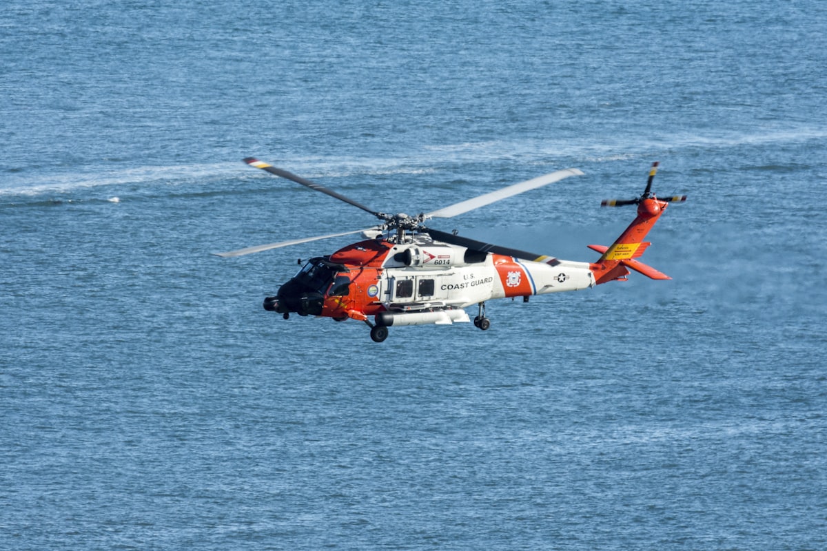 Recreational boats on the water with Coast Guard vessel in the background