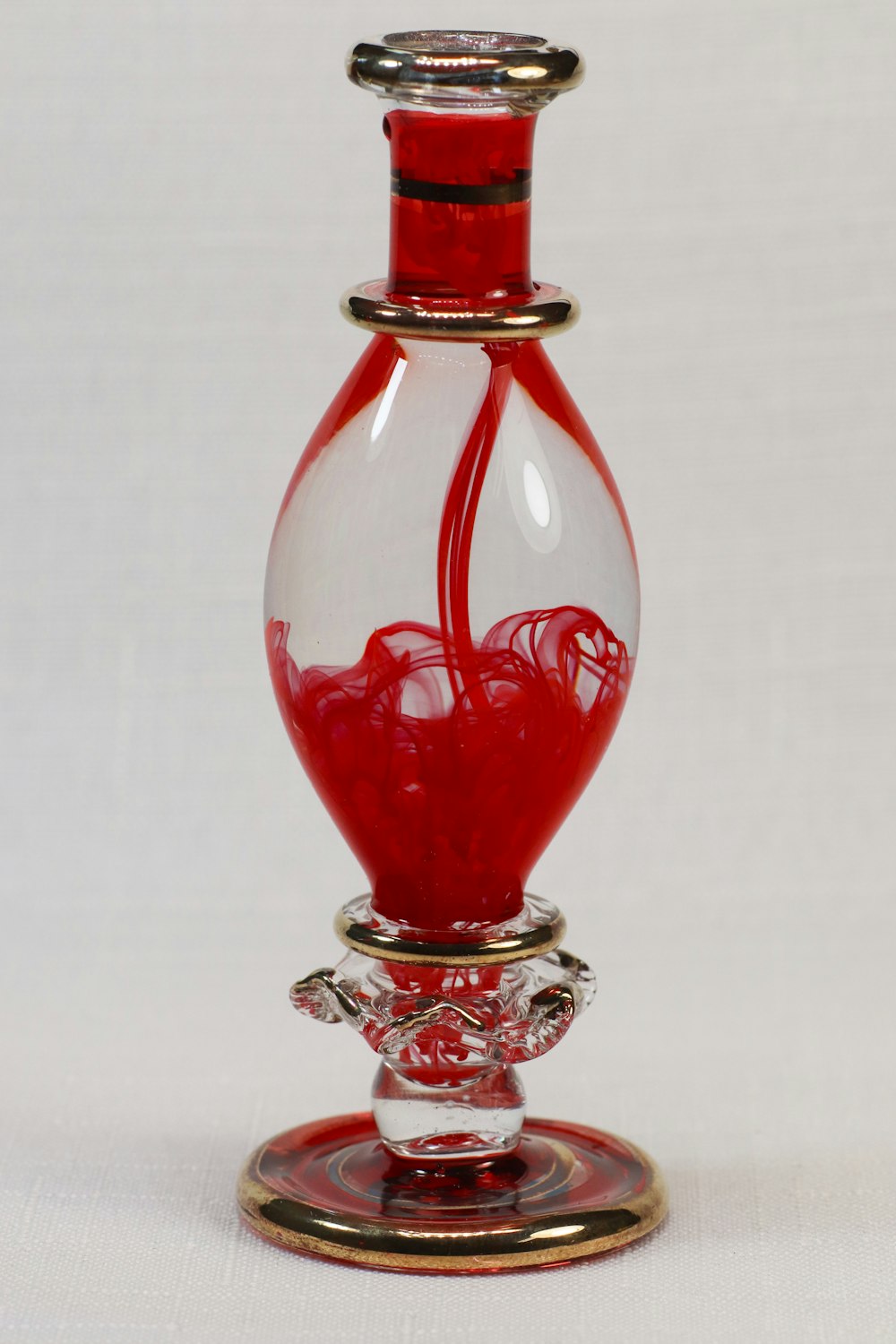 red and silver glass bottle