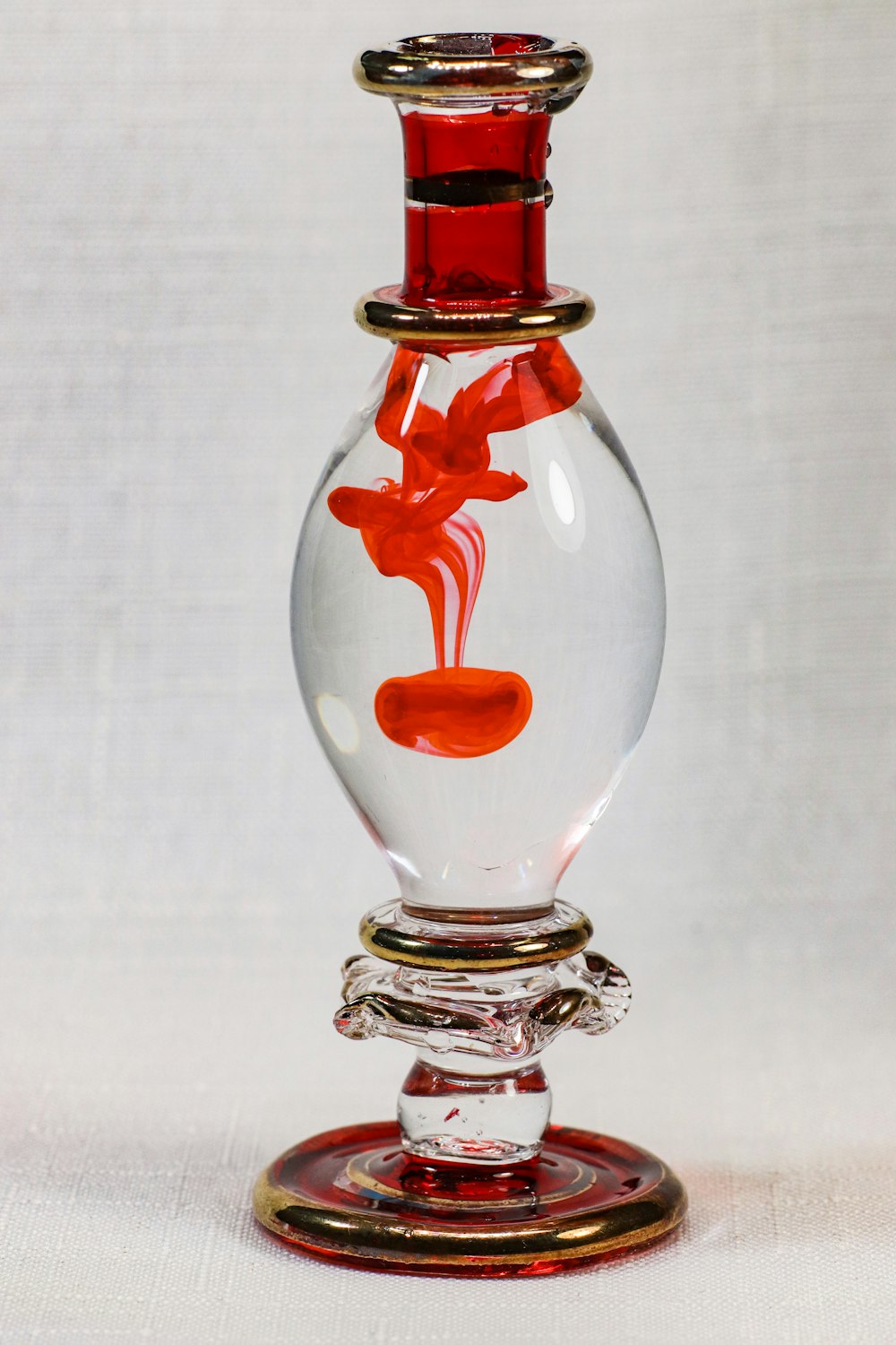 clear glass bottle with red liquid