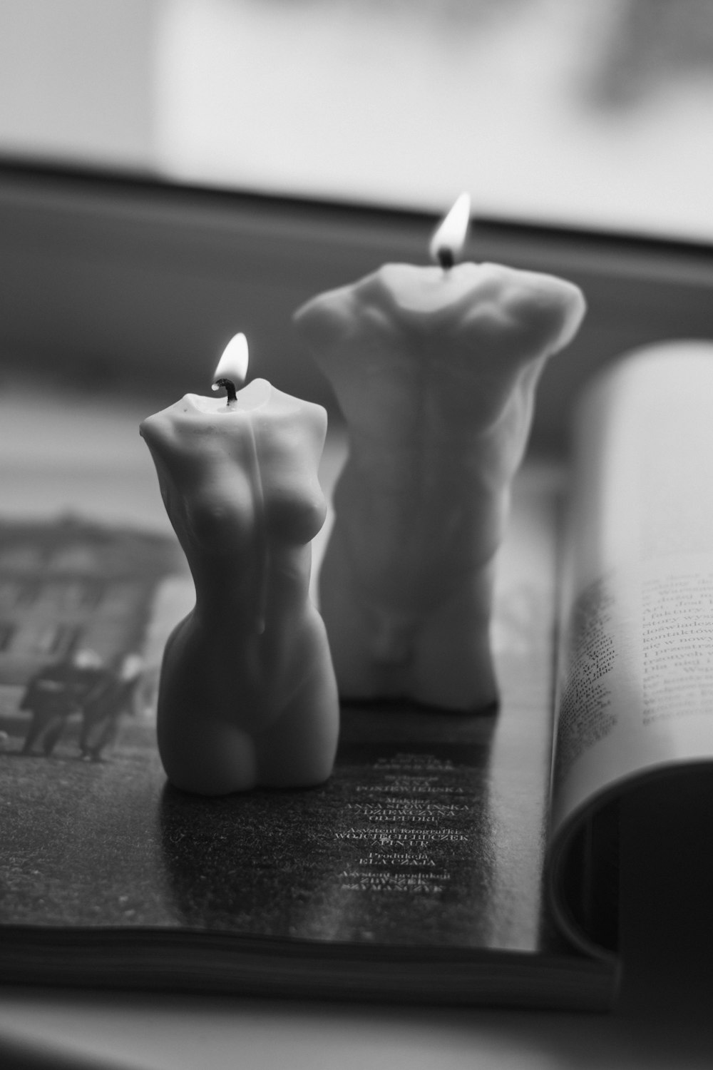 white pillar candle on black table