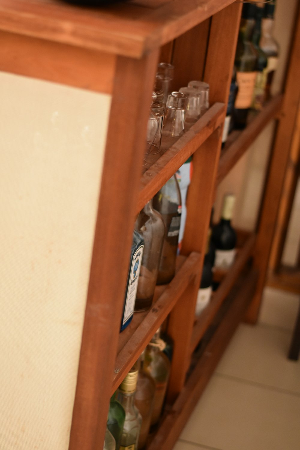 brown wooden shelf with bottles