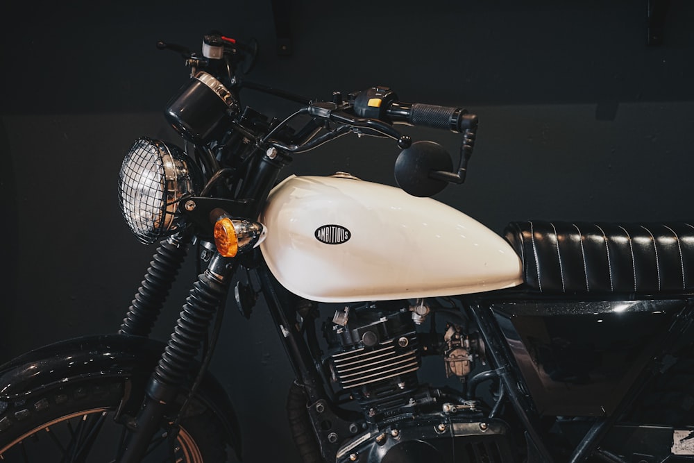 white and black motorcycle in a dark room