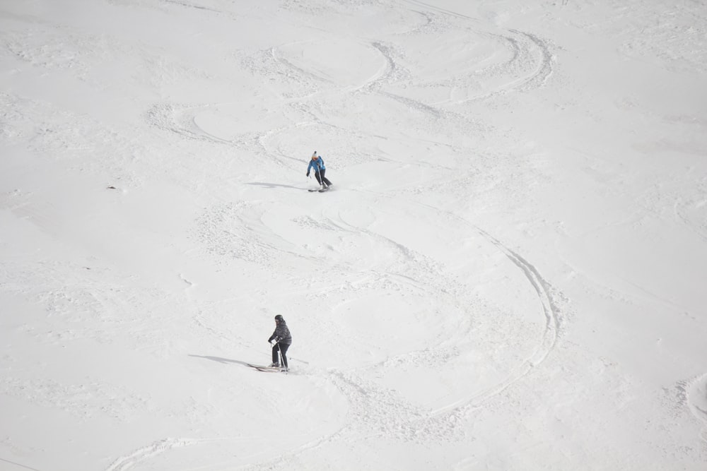 people walking on snow covered field during daytime