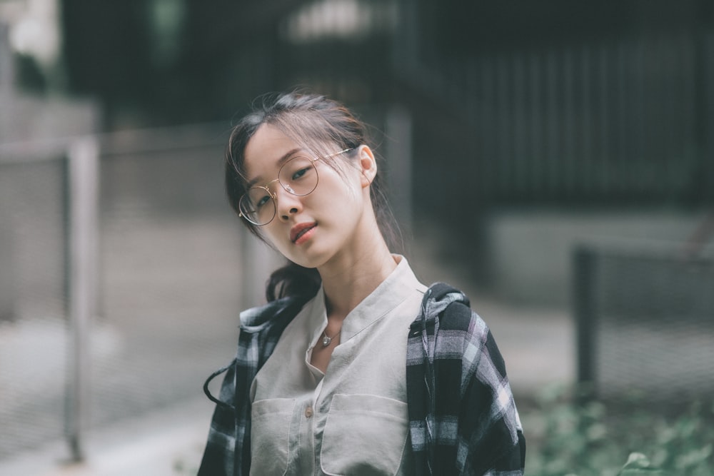 woman in black and white plaid button up shirt wearing eyeglasses