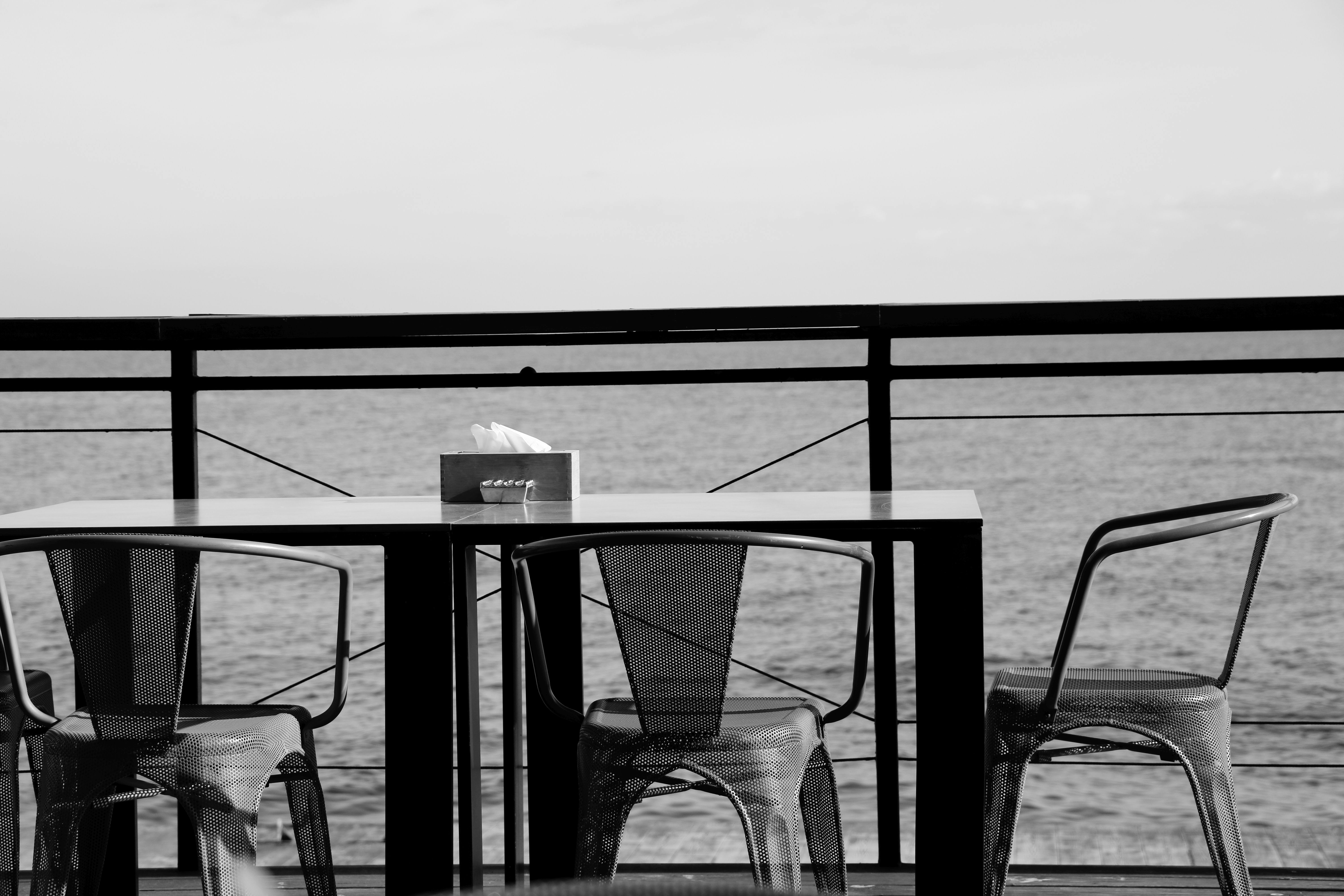 grayscale photo of a table and chairs