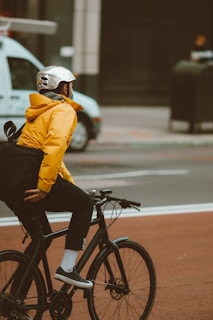 A sporty atmosgears jacket worn by a cyclist weaving through downtown traffic.