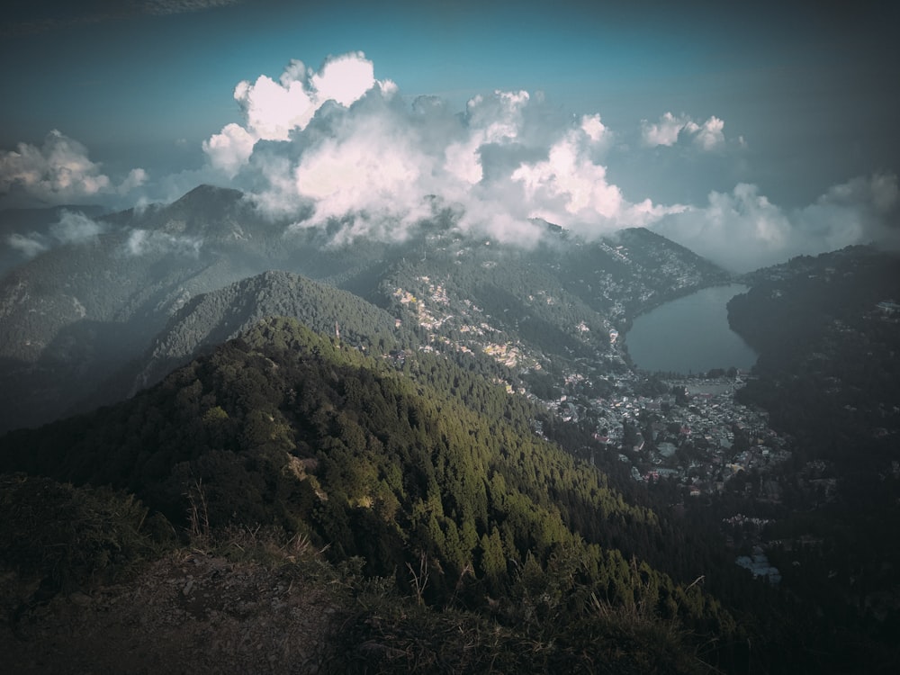 green and black mountains under blue sky and white clouds during daytime