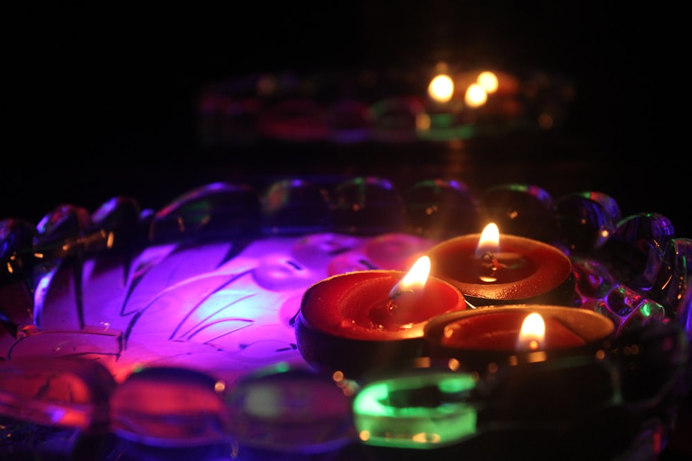 purple green and pink lighted candles