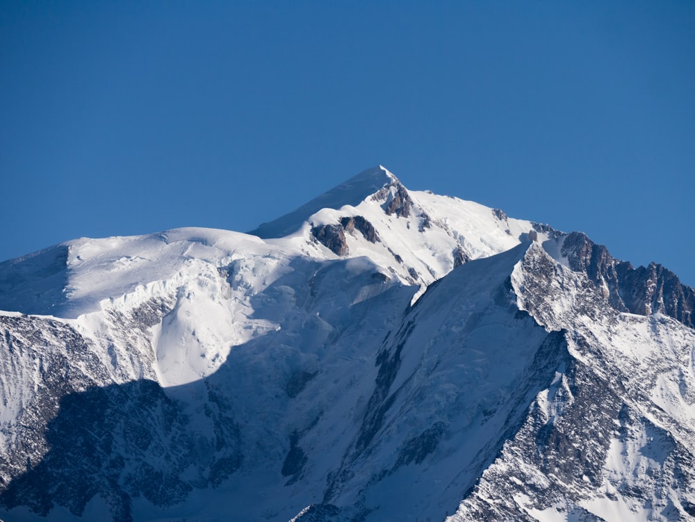 snow covered mountain under blue sky during daytime