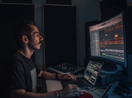man in gray crew neck t-shirt using computer
