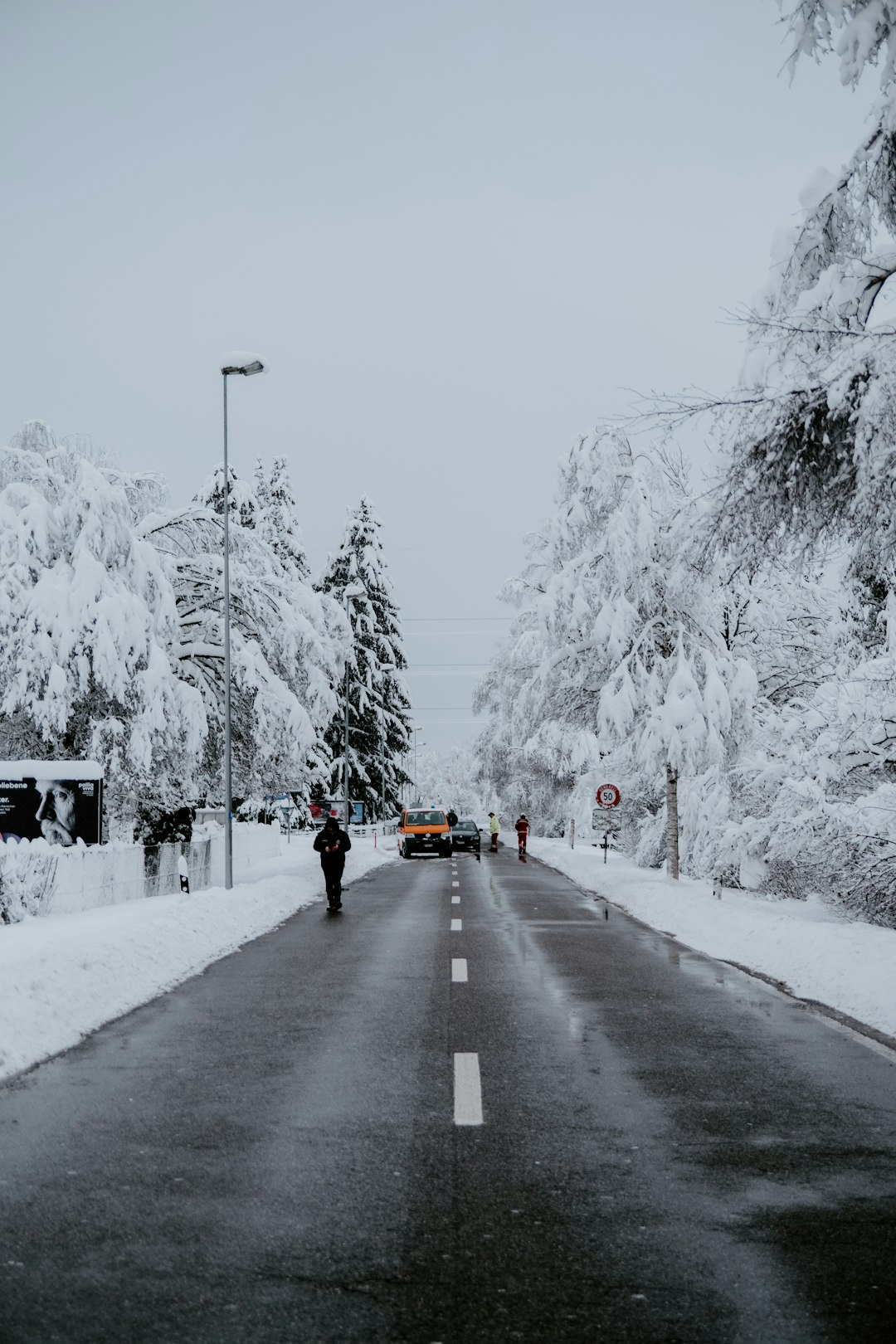 people walking on road covered with snow