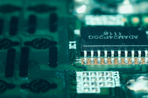 Close-up macro shot of a sleek FPGA chip with intricate circuitry glowing in electric cyan.
