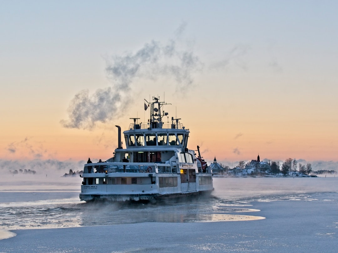 white and black boat on sea during daytime