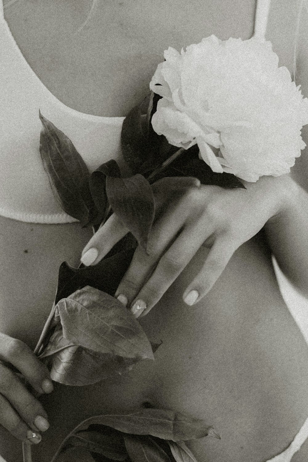 grayscale photo of woman holding flower