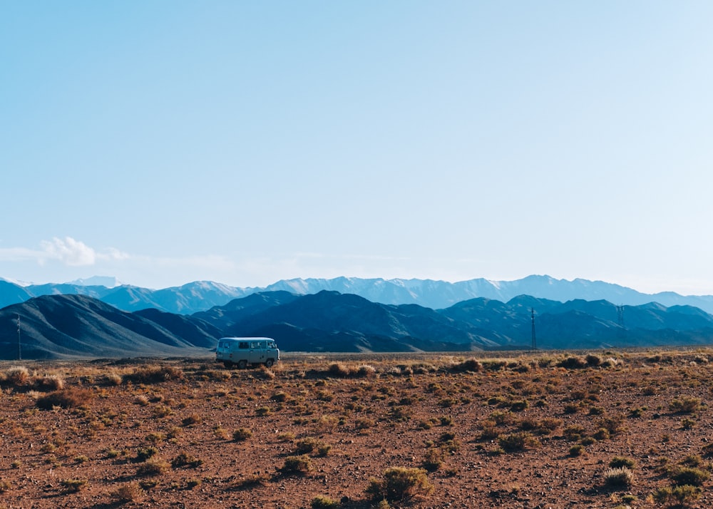 brown field near mountains during daytime