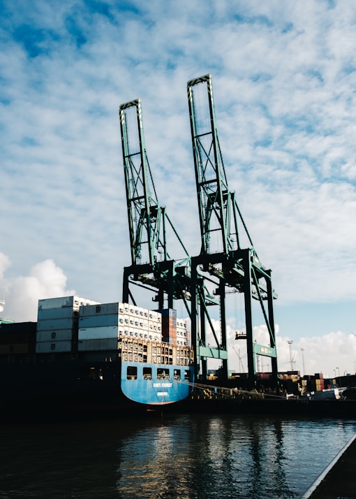 black metal crane under cloudy sky during daytime