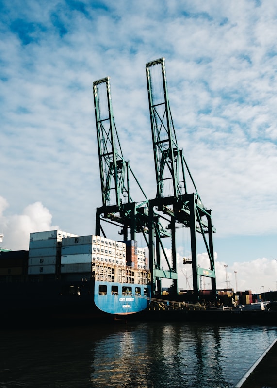 black metal crane under cloudy sky during daytime