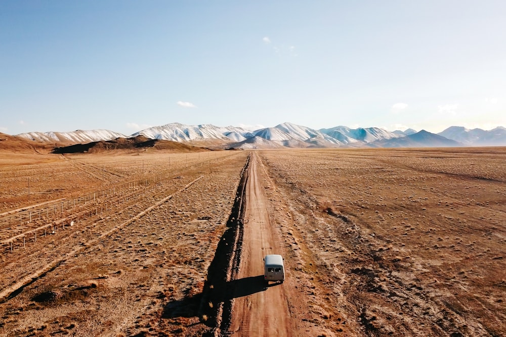 black metal rail road on brown sand