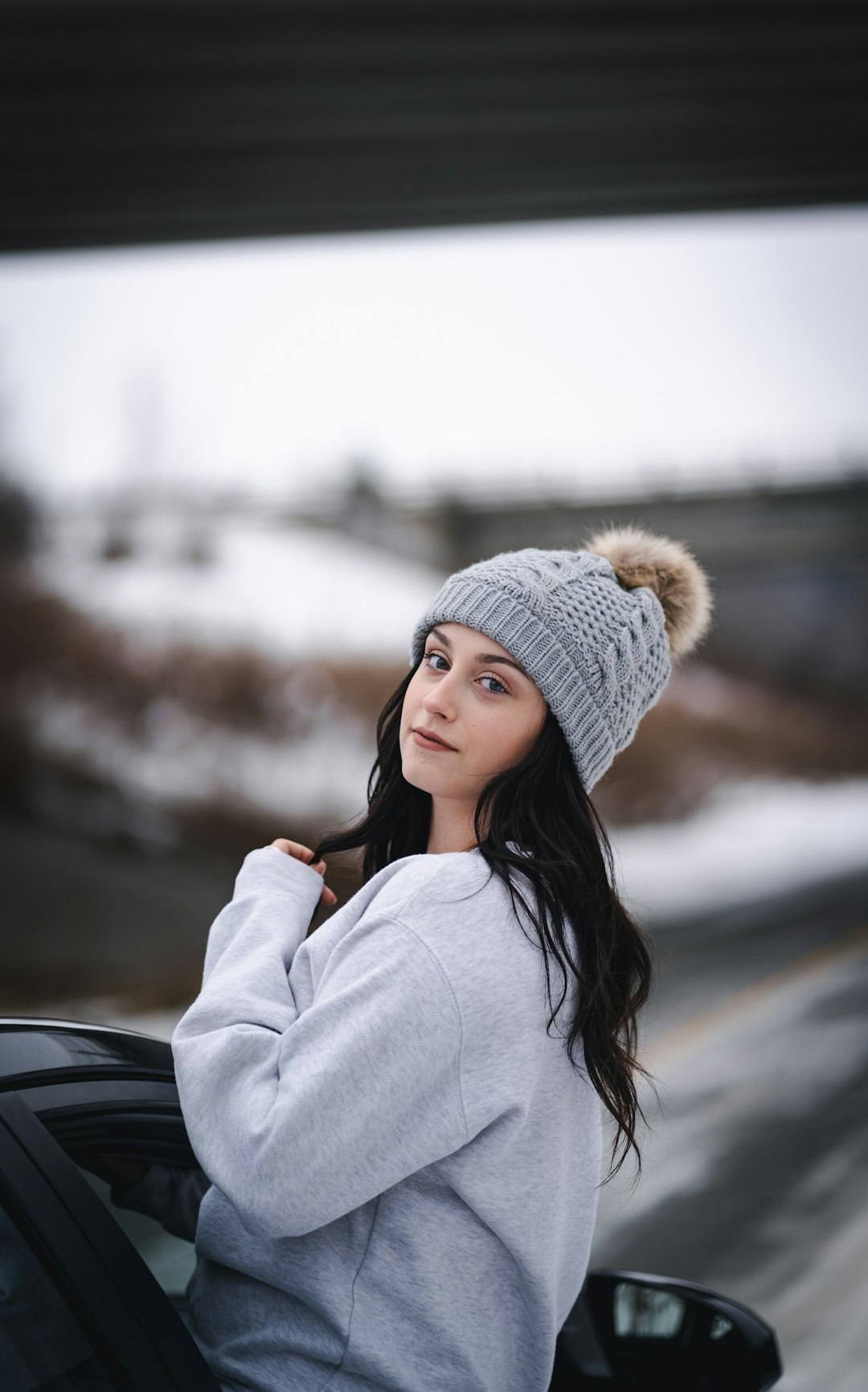 woman in white knit cap and white jacket