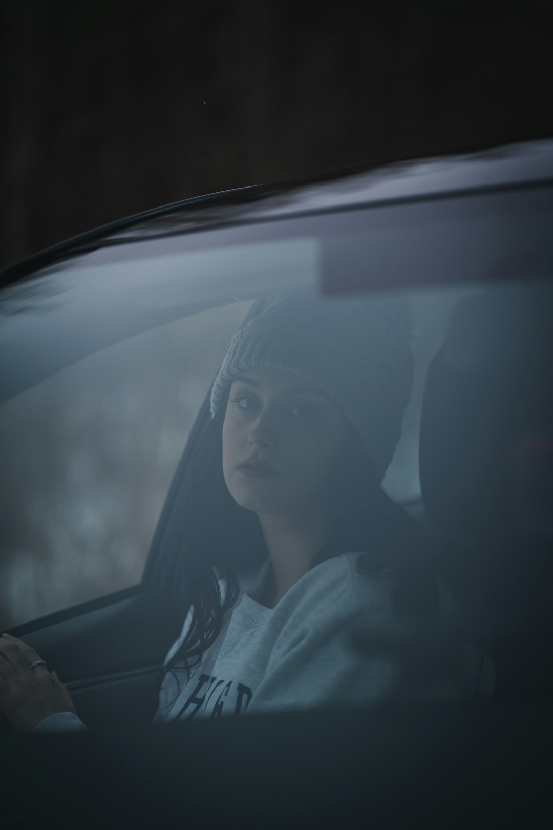 woman in white shirt sitting inside car