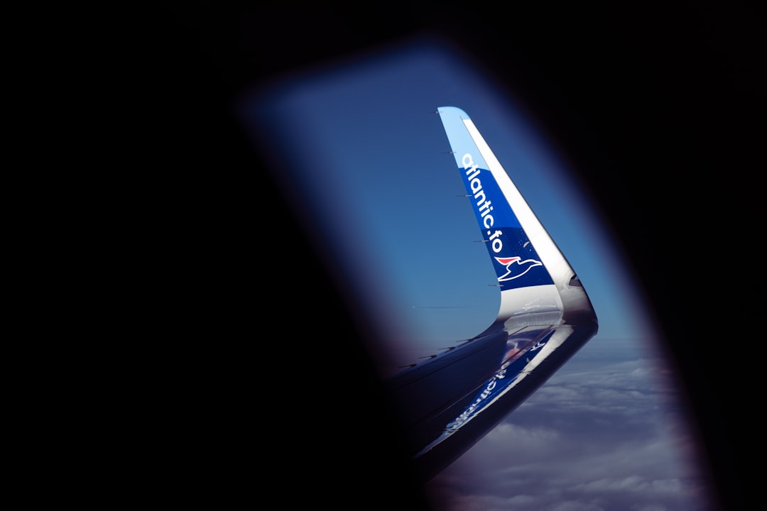 white and blue airplane wing, Spotting another flight over the wing of an Atlantic Airways flight