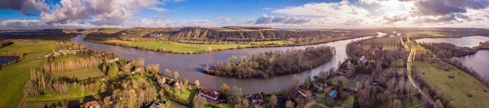 green trees near river under blue sky during daytime