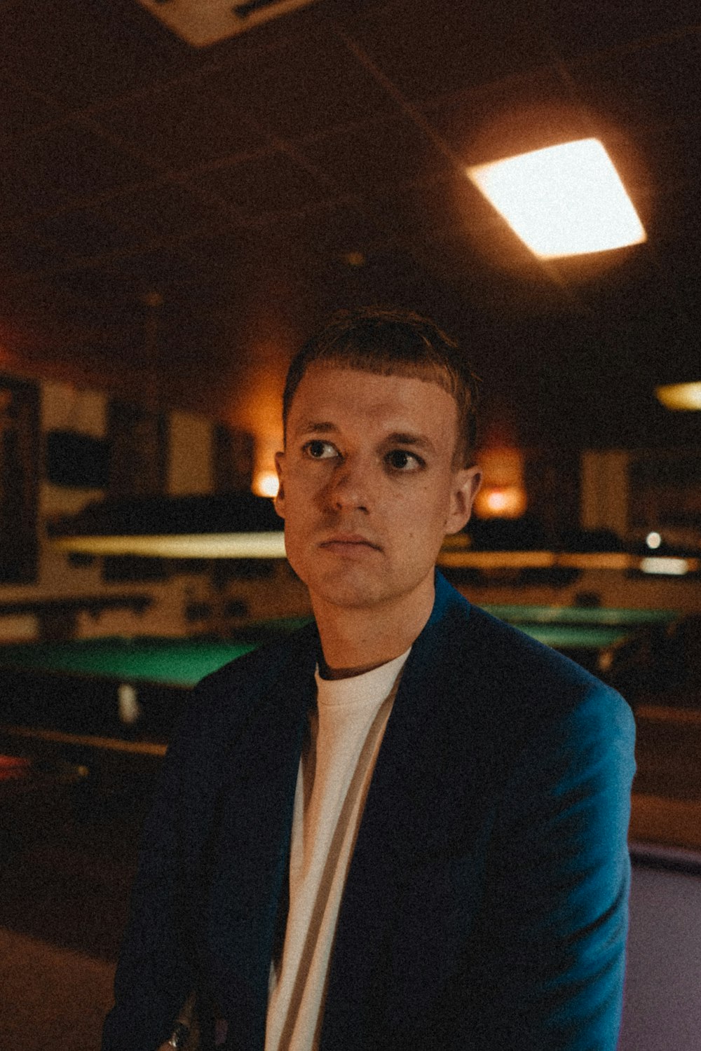 man in blue blazer standing