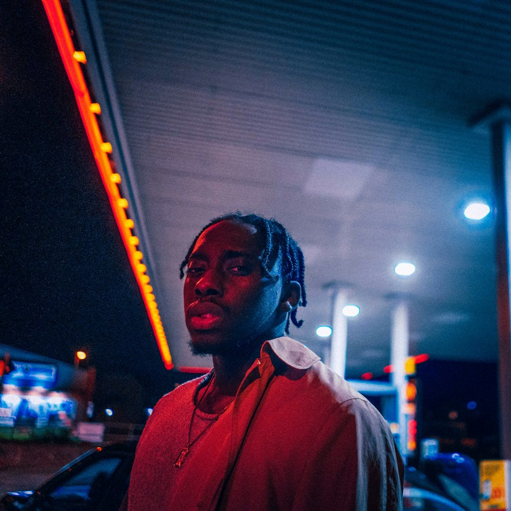 man in red polo shirt wearing blue headphones