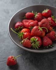 strawberries on white ceramic bowl