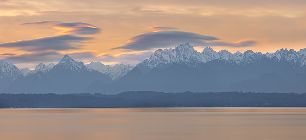 snow covered mountain during sunset