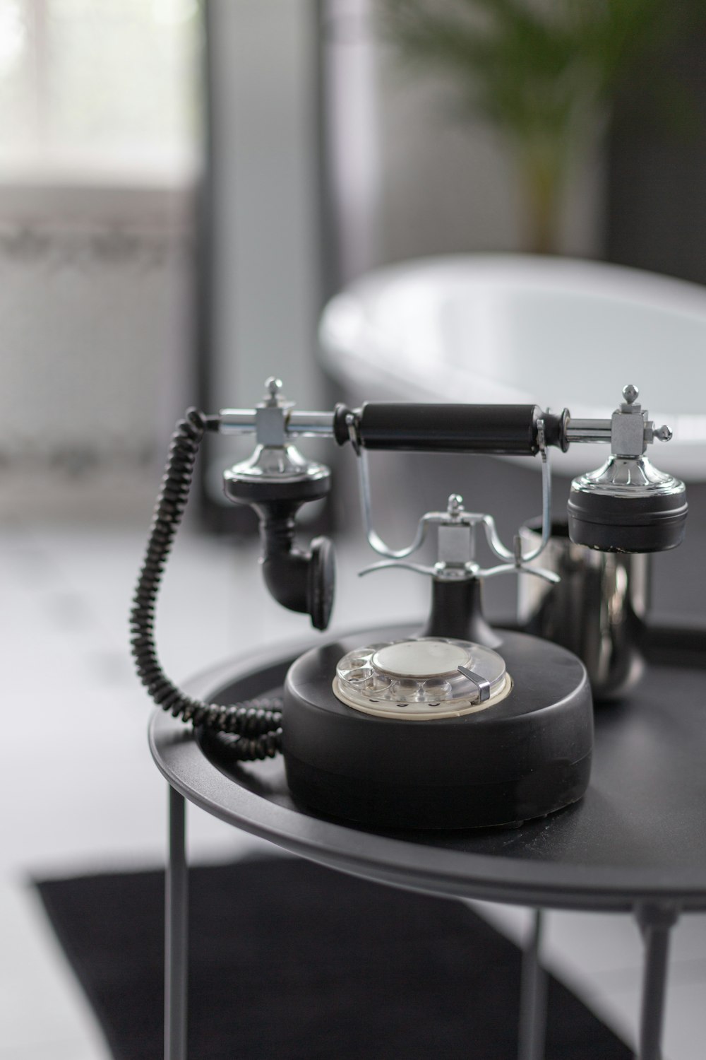 black and silver rotary phone on table